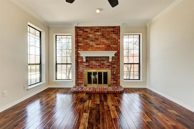 unfurnished living room with baseboards, a fireplace, crown molding, and hardwood / wood-style floors