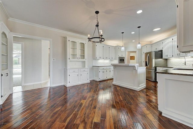 kitchen featuring crown molding, white cabinets, a kitchen island, and dark wood-style floors