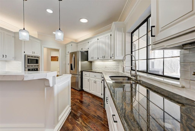 kitchen featuring stainless steel appliances, a sink, light stone countertops, dark wood-style floors, and crown molding