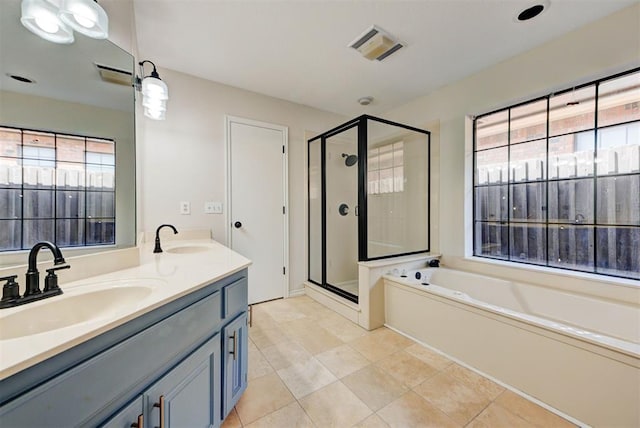 bathroom with a garden tub, a sink, and a shower stall