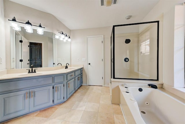 bathroom featuring a whirlpool tub, double vanity, a sink, and a shower stall