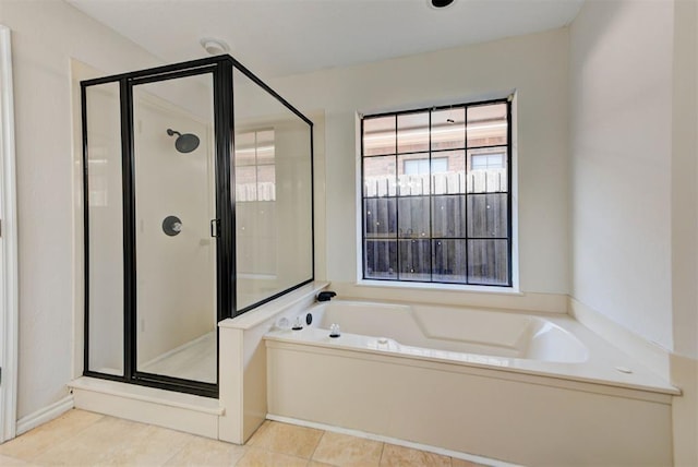 full bath featuring a stall shower, a garden tub, and tile patterned floors