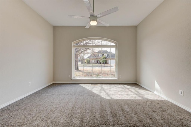 empty room with a ceiling fan, carpet flooring, and baseboards