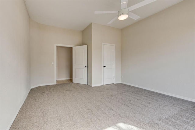 unfurnished bedroom with ceiling fan, carpet flooring, and baseboards