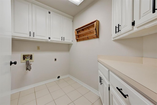 washroom with washer hookup, cabinet space, light tile patterned flooring, electric dryer hookup, and baseboards