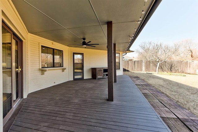 wooden deck featuring a ceiling fan and fence