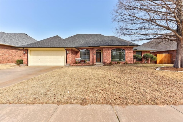 3705 Barwick Dr, Norman, OK 73072 - view of front facade featuring a garage, concrete driveway, brick siding, and a front yard