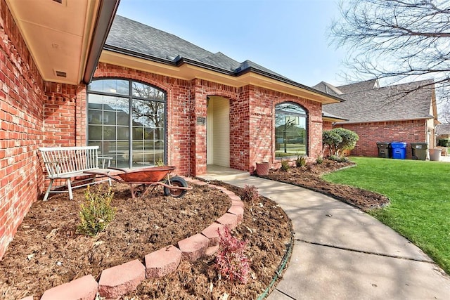 3705 Barwick Dr, Norman, OK 73072 - entrance to property featuring brick siding, roof with shingles, and a lawn