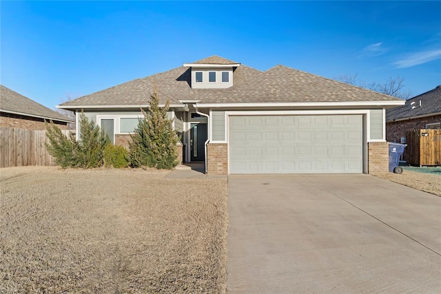 view of front of property featuring a garage, concrete driveway, roof with shingles, fence, and brick siding