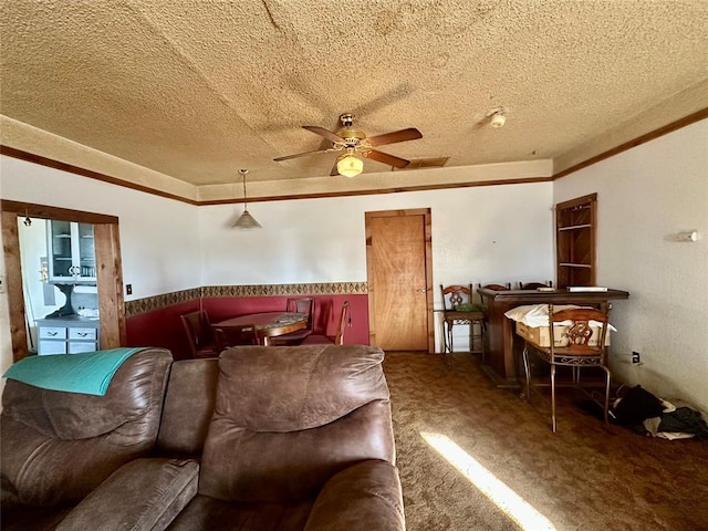 carpeted living area featuring a textured ceiling and a ceiling fan