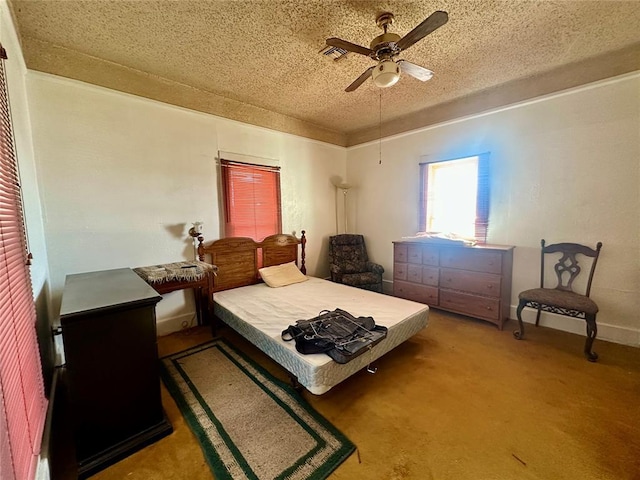 carpeted bedroom featuring a ceiling fan, a textured ceiling, and baseboards