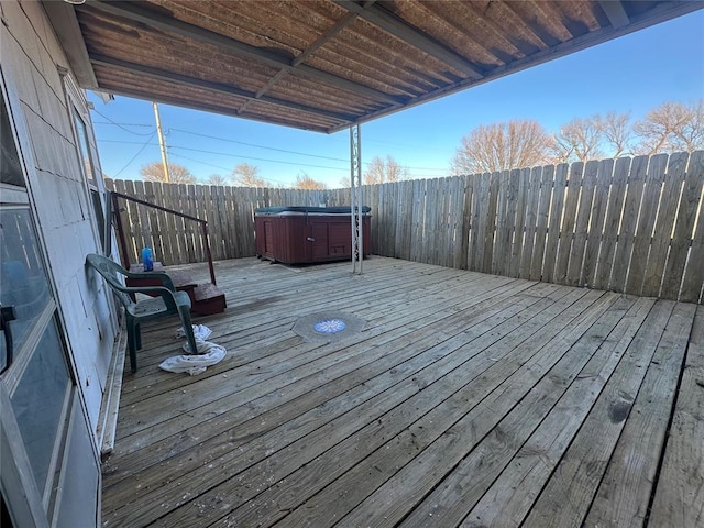 deck featuring fence private yard and a hot tub