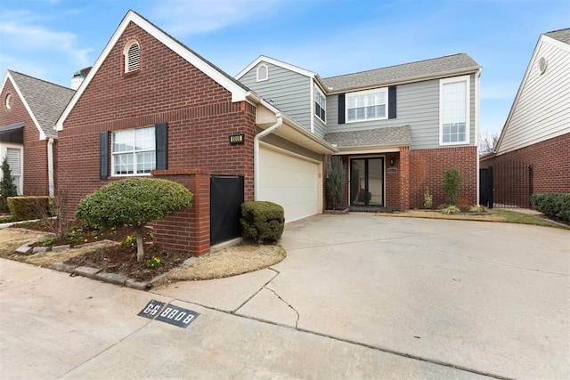 traditional-style home featuring driveway, a garage, and brick siding