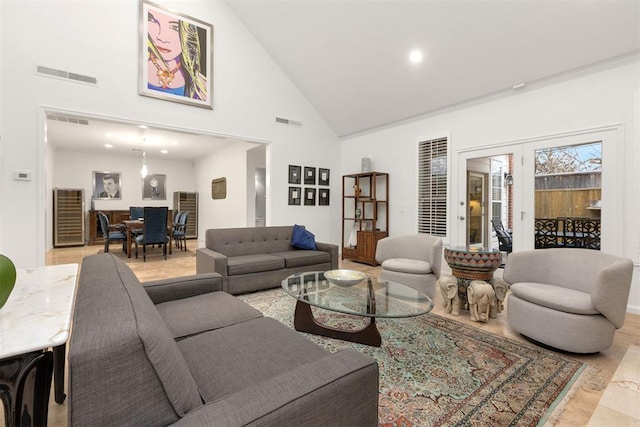 living room with high vaulted ceiling and visible vents