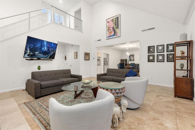 living area with baseboards, visible vents, and light tile patterned flooring