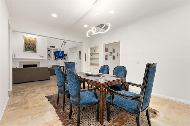 dining space with built in shelves, a tile fireplace, recessed lighting, baseboards, and an inviting chandelier