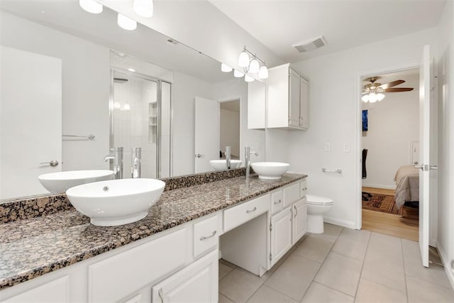 ensuite bathroom featuring double vanity, connected bathroom, and a sink