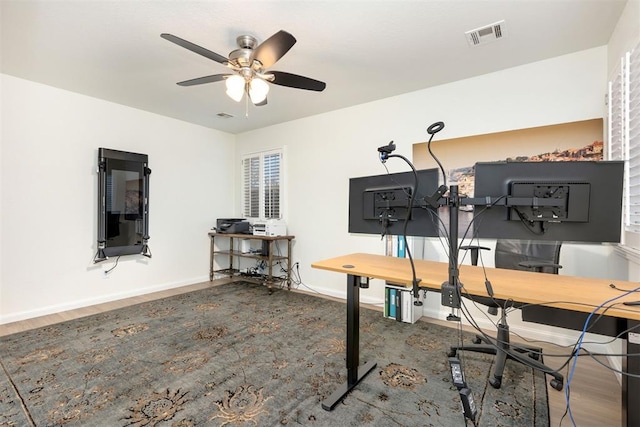 office featuring baseboards, visible vents, and a ceiling fan