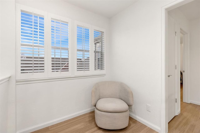 sitting room featuring light wood-type flooring and baseboards