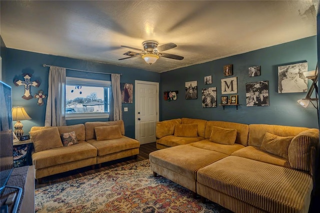 living room with ceiling fan, wood finished floors, and visible vents