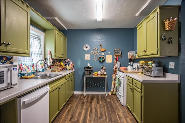 kitchen with green cabinets, light countertops, and white appliances