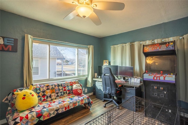 office with ceiling fan, a textured wall, wood finished floors, and baseboards