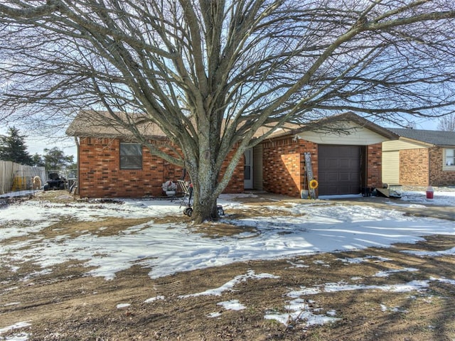 view of front of house featuring brick siding and an attached garage