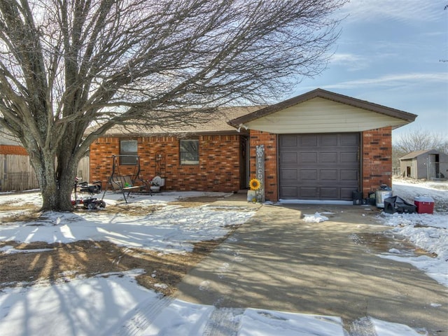 view of front of home featuring a garage, brick siding, and driveway