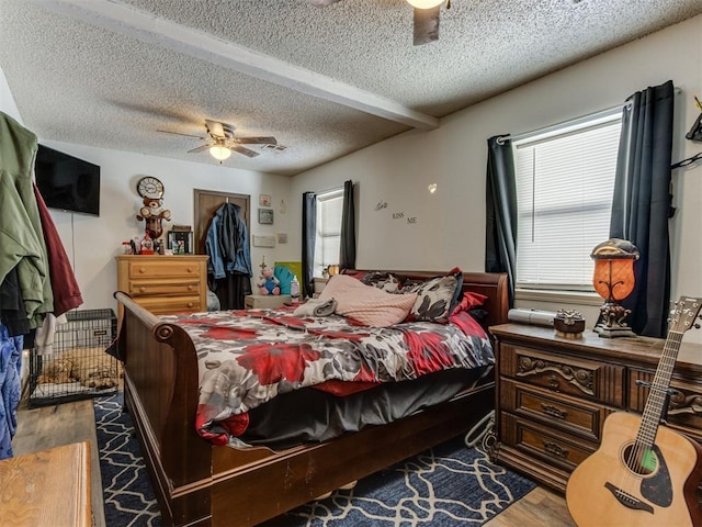 bedroom featuring a textured ceiling, ceiling fan, a closet, and wood finished floors