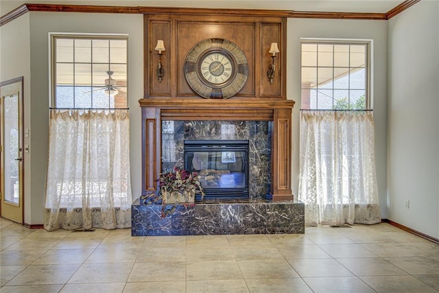 unfurnished living room featuring a fireplace, ornamental molding, a wealth of natural light, and tile patterned floors