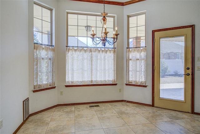 unfurnished dining area featuring a healthy amount of sunlight, an inviting chandelier, light tile patterned floors, and baseboards