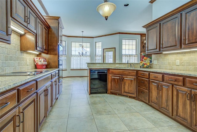 kitchen featuring light tile patterned floors, decorative light fixtures, crown molding, black appliances, and a sink