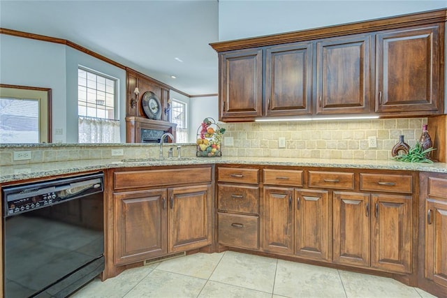 kitchen featuring crown molding, dishwasher, decorative backsplash, and a sink