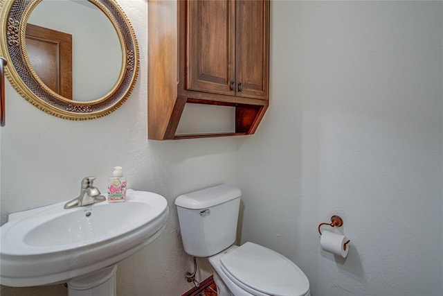 half bathroom with a sink and toilet