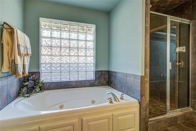 full bath featuring a stall shower and a tub with jets