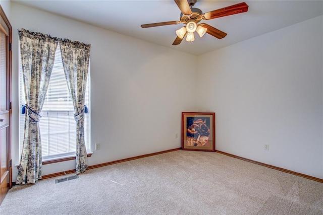 unfurnished room with baseboards, visible vents, ceiling fan, and carpet flooring