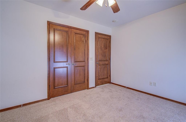 unfurnished bedroom featuring carpet, ceiling fan, and baseboards