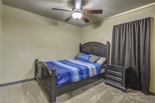 bedroom featuring ceiling fan, visible vents, and light colored carpet