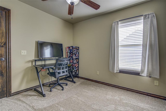 home office with light carpet, ceiling fan, and baseboards