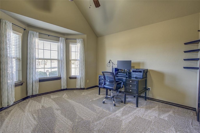 office area featuring vaulted ceiling, ceiling fan, baseboards, and light colored carpet