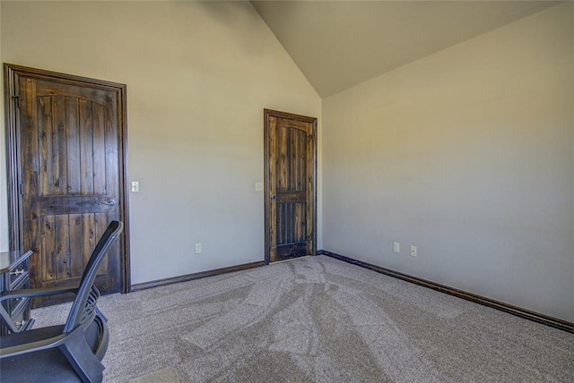 interior space with high vaulted ceiling, light carpet, and baseboards