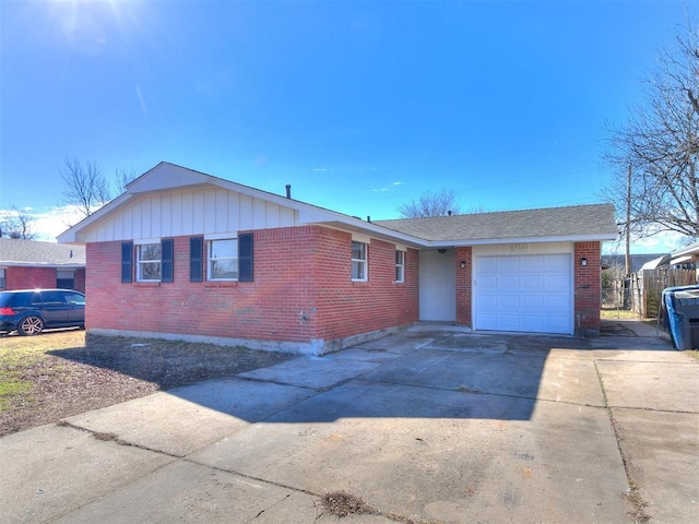 ranch-style house with a garage, brick siding, and driveway