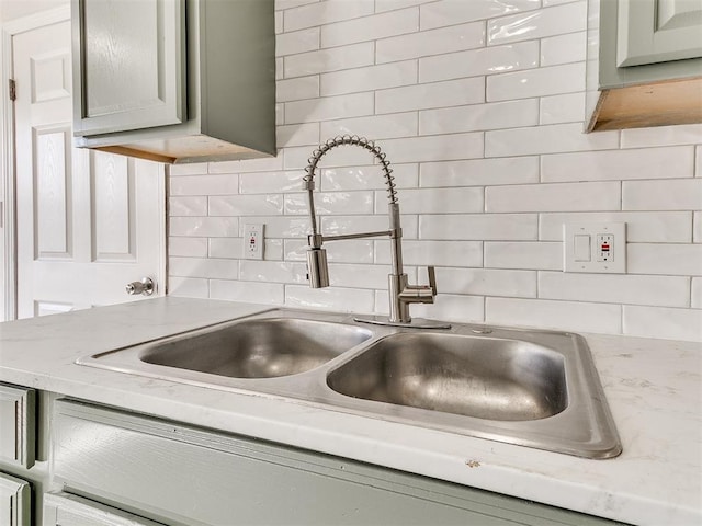 details featuring backsplash and a sink