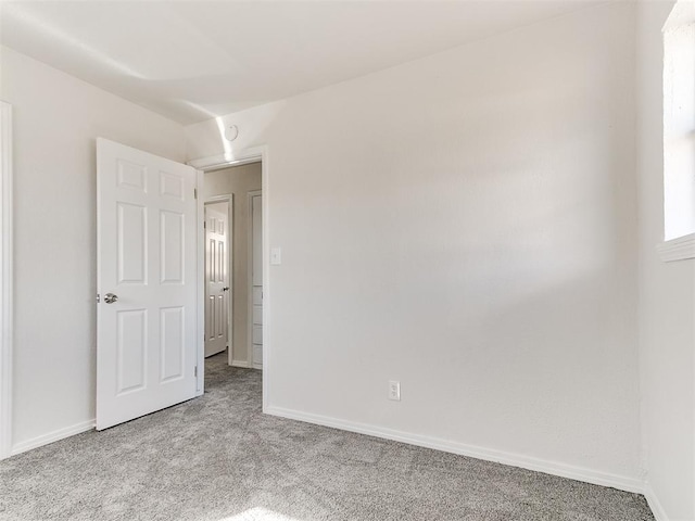 unfurnished bedroom with baseboards and light colored carpet