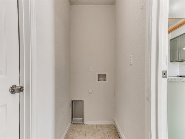 washroom featuring light tile patterned floors, hookup for a washing machine, hookup for an electric dryer, laundry area, and baseboards