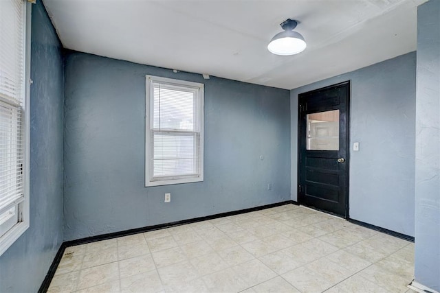 spare room featuring baseboards