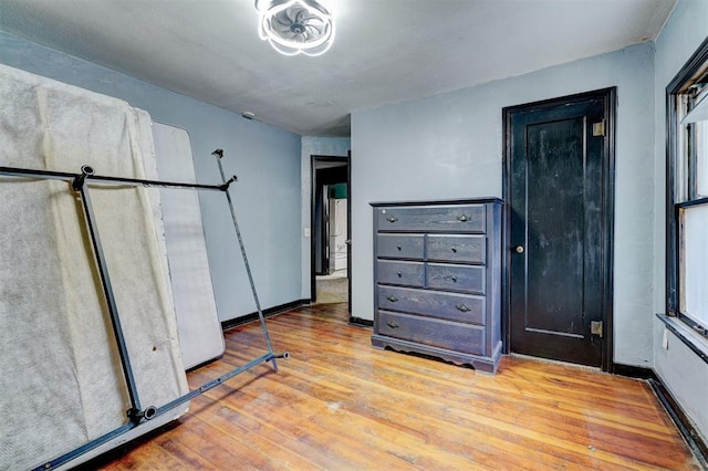 unfurnished bedroom featuring baseboards and hardwood / wood-style flooring