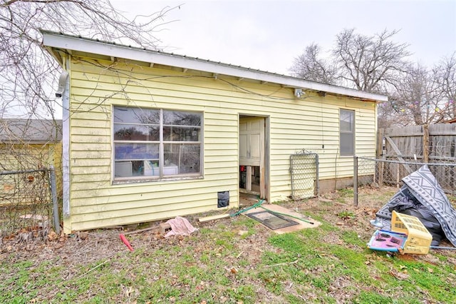 rear view of property with fence