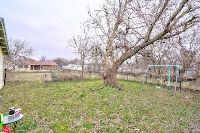 view of yard with fence and a playground