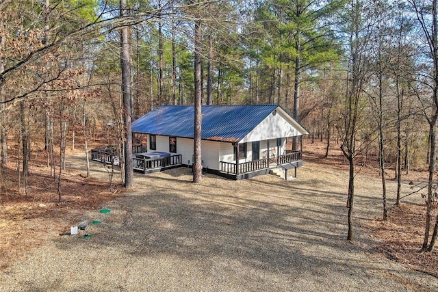 view of front of house with metal roof and a wooden deck